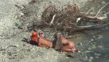 Couple fucking on a public beach, while walking past people